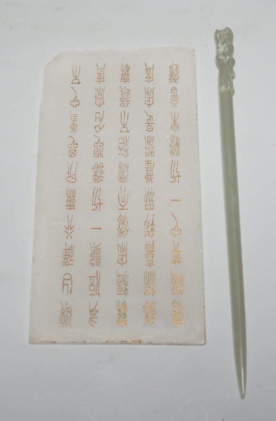 A Chinese carved stone tablet, 15.5 x 7.8 cm and a hair pin